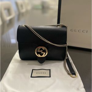 Gucci Crossbody Bag features traditional black leather exterior and Gucci Clasp